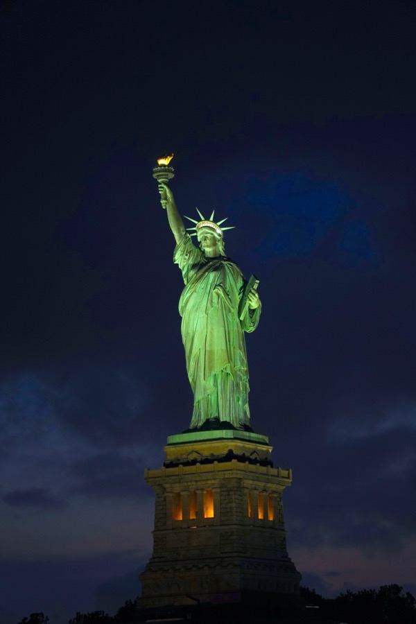Statue of Liberty lit up at night
