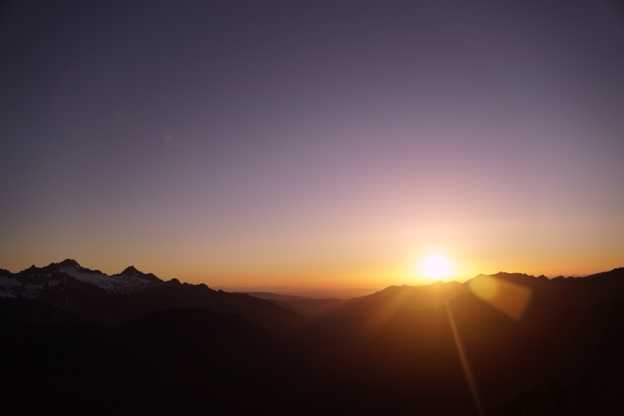 Sun setting behind Black Buttes and Twin Sisters
